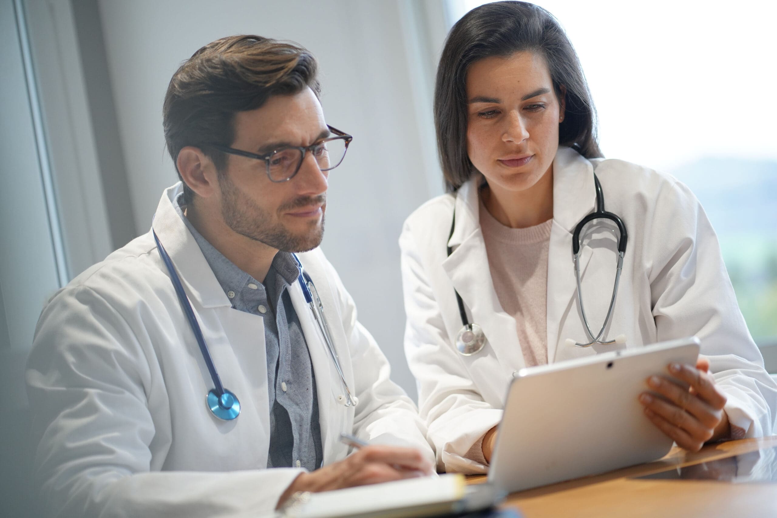 Male and female doctors going through patient's results